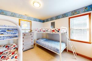a bedroom with two bunk beds and a drawer at Ocean Song #3-CA in Avon +30 photos
