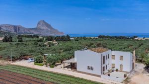 a house with a view of the ocean and mountains at B&B Pietre Preziose in Castelluzzo