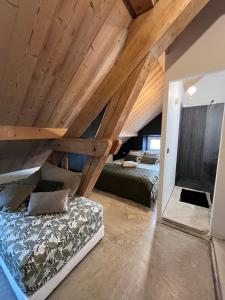 a bedroom with a bed and a wooden ceiling at Refuges sous les toits in Bourg-Saint-Maurice