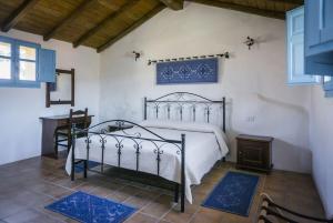 a bedroom with a bed and a table in a room at Albergo Diffuso Il Mandorlo in Baressa