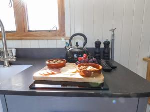 a kitchen counter with two bowls of food on a cutting board at Cariad Bach in Rhyl