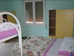 a small bedroom with a bed and a dresser at Borno B&B in Borno