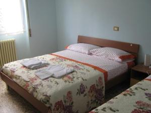 a bedroom with a bed with towels on it at Borno B&B in Borno