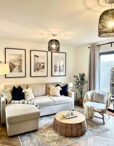 a living room with a couch and a table at The Nook - Cosy coastal retreat near Sandbanks in Poole