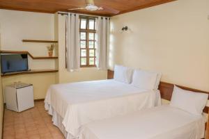 Cama ou camas em um quarto em Casarão Alpina