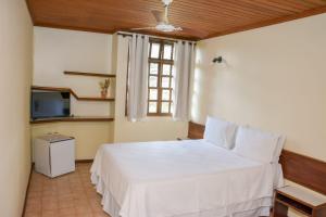 Cama ou camas em um quarto em Casarão Alpina