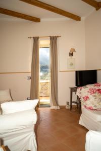 a room with two beds and a window at Donna Carmela Apartment in Scala