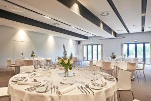 a room with tables and chairs with white tablecloths at Cascade Wellness Resort in Lagos +37 photos