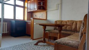 uma sala de estar com uma mesa e um sofá em Rent Apartment Negruzzi Street em Chişinău