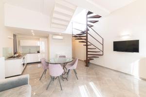 a kitchen and dining room with a glass table and chairs at Casa Umberto I , Taormina Centro in Taormina