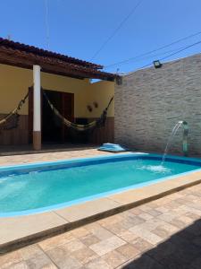 a swimming pool in front of a house at Toca do hamster - MILAGRES in São Miguel dos Milagres