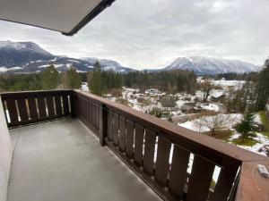 a balcony with a view of snow covered mountains at Dachstein Panorama-Lodge in Bad Goisern