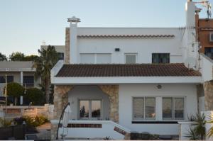 ein weißes Haus mit einer Treppe davor in der Unterkunft Casa Mar i Sol in L'Ampolla