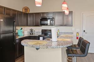 a kitchen with a black refrigerator and a counter top at Cozy Indy Get Away - Private Room - Shared in Indianapolis