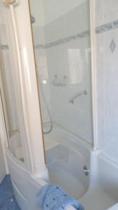 een witte badkamer met een douche en een toilet bij Apolloni di Loano appartamento privato - Codici Citra visibili su STRUTTURA in Loano