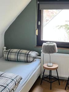 a bedroom with a bed and a chair and a window at Ferienwohnung Meijer in Briedel