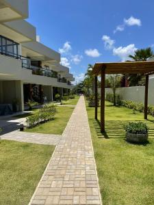 a brick pathway leading to a building at Itacimirim Beira Mar in Itacimirim