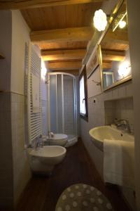 a bathroom with a sink and a toilet and a mirror at B&B Casa Perla in Chioggia