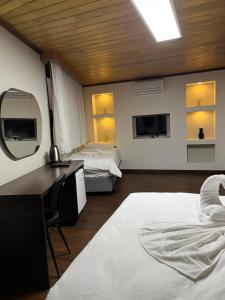 A bed or beds in a room at Gold Corner Hotel
