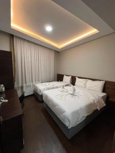 A bed or beds in a room at Gold Corner Hotel