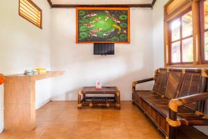 a living room with a couch and a table at OYO 2278 Cikidang Hunting Resort in Sukabumi
