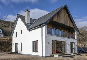 a white house with a black roof at Ardbrae in Spean Bridge