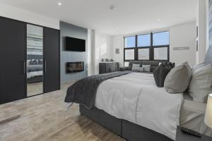 a bedroom with a large bed and a television at Stayover Suites in Ballymena +14 photos