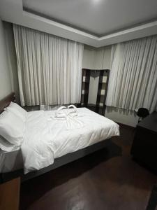 A bed or beds in a room at Gold Corner Hotel