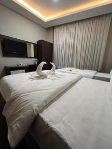 A bed or beds in a room at Gold Corner Hotel