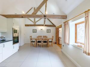 a kitchen and dining room with a table and chairs at Old Root House, Lavant in Chichester