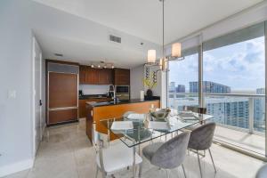 a kitchen and dining room with a glass table with chairs at Wonderful 2/2 Condo at Icon Brickell With Pool in Miami