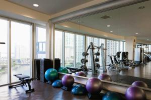 a fitness room with exercise equipment and large windows at Wonderful 2/2 Condo at Icon Brickell With Pool in Miami