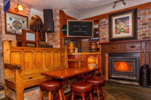 a bar with a wooden table and a fireplace at Charlie Foleys in Killarney