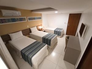 Postel nebo postele na pokoji v ubytování Slim Pajuçara by Tropicalis