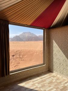 a room with a window with a view of the desert at Panorama camp jeep trips in Wadi Rum