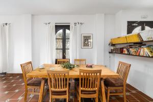 a dining room with a wooden table and chairs at Cerro de Hijar in Tolox