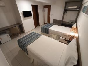Postel nebo postele na pokoji v ubytování Slim Pajuçara by Tropicalis