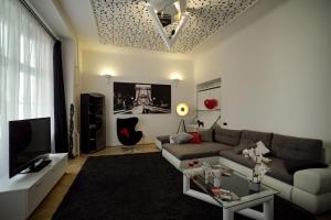 a living room with a couch and a tv at Phoenix Apartment in Budapest