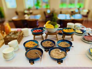 a table topped with bowls of food and plates of food at Glenlyn Hotel & Apartments in Barnet