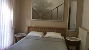 a bedroom with a bed with two sinks and a bridge at Seaflows Apartments #3 in Paralia Katerinis