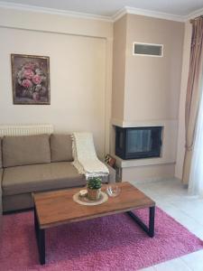 a living room with a couch and a coffee table at Seaflows Apartments #3 in Paralia Katerinis
