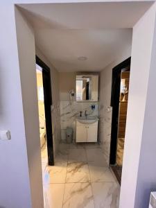a bathroom with a sink and a mirror at Sarı Konak in Antalya