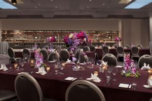 a conference room with a long table with chairs and flowers at SAHARA Las Vegas in Las Vegas +37 photos