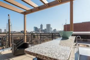 a balcony with a table and a view of the city at Private Bedroom Downtown INDY - Shared in Indianapolis