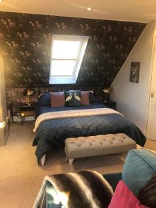 a bedroom with a large bed and a window at Clouds B&B in Kilmuir