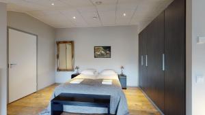 a bedroom with a bed and a wooden floor at Sandy Kelt - Irish House Apartments in Kalajoki