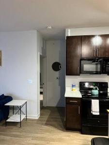 a kitchen with a stove and a microwave at Private Bedroom Fountain Square - Shared in Indianapolis