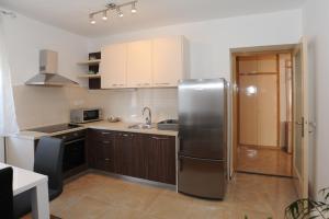 a kitchen with a stainless steel refrigerator at Voshta 2 bedroom apartment in Zadar