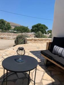 a table and a couch on a patio at Villa Laugh, on The Limnes Beach in Kampos Paros