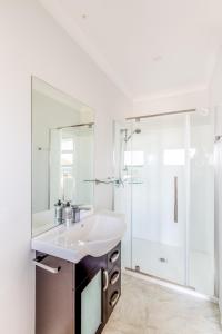 a white bathroom with a sink and a shower at Roto View - Beautiful views of Lake Tekapo in Lake Tekapo